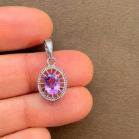 silver pendant with 5x7 mm oval brazilian amethyst displayed on hand