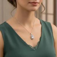 model wearing silver pendant with 5x7 mm oval cab rainbow moonstone