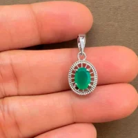 silver pendant with 5x7 mm oval green onyx displayed on hand