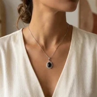 model wearing silver pendant with 5x7 mm oval black onyx