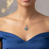 model wearing silver pendant butterfly shaped with 5x7 mm oval swiss blue topaz