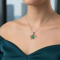 model wearing silver pendant butterfly shaped with 5x7 mm oval green onyx