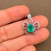 silver pendant butterfly shaped with 5x7 mm oval green onyx displayed on hand