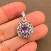 silver pendant with 5x7 mm oval brazilian amethyst displayed on hand