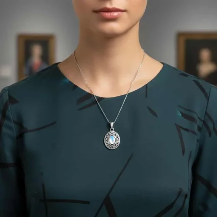 model wearing silver pendant with 5x7 mm oval rainbow moonstone