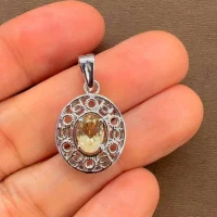 silver pendant with 5x7 mm oval citrine displayed on hand