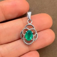 silver pendant with 5x7 mm oval green onyx displayed on hand
