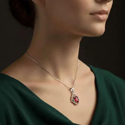 model wearing silver pendant with 5x7 mm oval garnet
