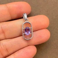silver pendant with 5x7 mm oval brazilian amethyst displayed on hand