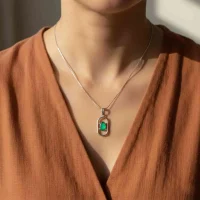 model wearing silver pendant with 5x7 mm oval green onyx