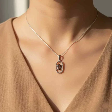 model wearing silver pendant with 5x7 mm oval smoky quartz
