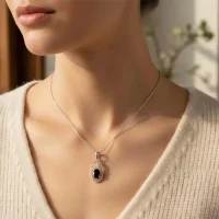 model wearing silver pendant with 5x7 mm oval black onyx