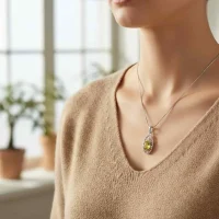 model wearing silver pendant with 5x7 mm oval peridot
