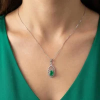 model wearing silver pendant with 5x7 mm oval green onyx