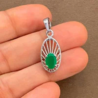 silver pendant with 5x7 mm oval green onyx displayed on hand