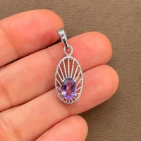 silver pendant with 5x7 mm oval brazilian amethyst displayed on hand