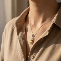 model wearing silver pendant with 5x7 mm oval citrine