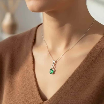 model wearing silver pendant with 5x7 mm oval green onyx