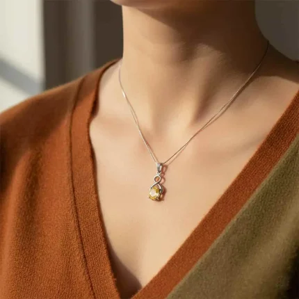 model wearing silver pendant with 5x7 mm oval citrine