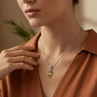 model wearing silver pendant with 6x4 mm oval peridot