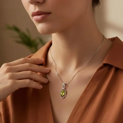 model wearing silver pendant with 6x4 mm oval peridot