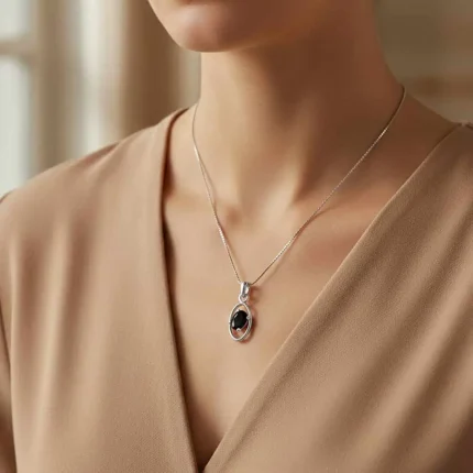 model wearing silver pendant with 6x4 mm oval black onyx