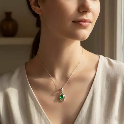 model wearing silver pendant with 6x4 mm oval green onyx