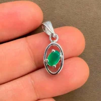 silver pendant with 6x4 mm oval green onyx displayed on hand