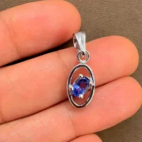 silver pendant with 6x4 mm oval iolite displayed on hand