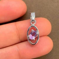 silver pendant with 6x4 mm oval brazilian amethyst displayed on hand
