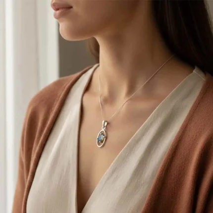 model wearing silver pendant with 6x4 mm oval labradorite