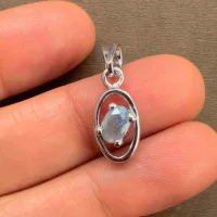 silver pendant with 6x4 mm oval labradorite displayed on hand