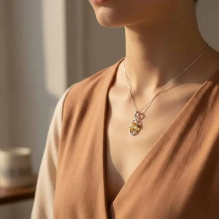 model wearing silver pendant with 6x4 mm oval citrine