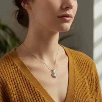 model wearing silver pendant heart shaped with 6x4 mm oval rainbow moonstone