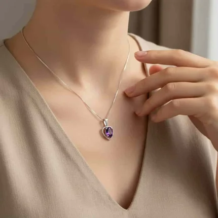 model wearing silver pendant heart shaped with 6x4 mm oval amethyst