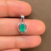 silver pendant heart shaped with 6x4 mm oval green onyx displayed on hand