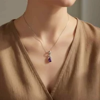 model wearing silver pendant with 6x4 mm pear amethyst