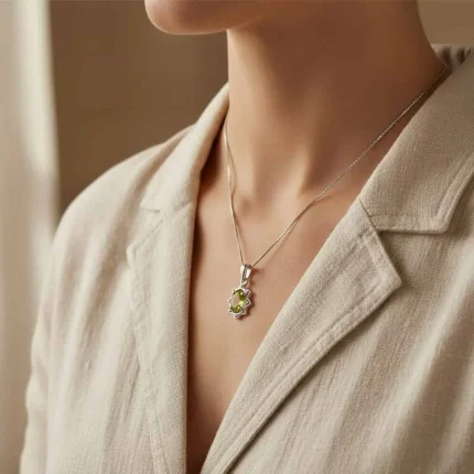 model wearing silver pendant with 6x4 mm oval peridot