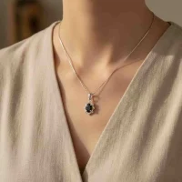 model wearing silver pendant with 6x4 mm oval black onyx