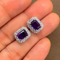 silver studs cluster with 5x7 mm octagon Amethyst and cubic zirconia displayed on hand