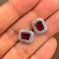 silver studs cluster with 5x7 mm octagon Garnet and cubic zirconia displayed on hand