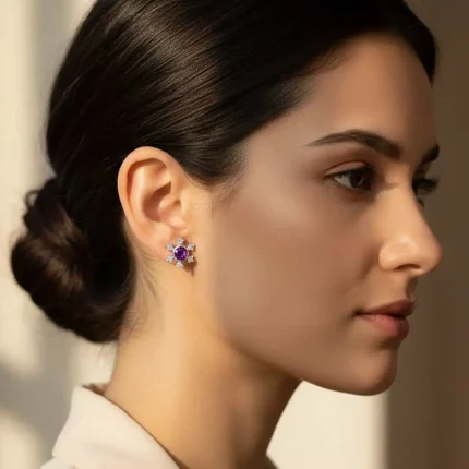 model wearing silver studs snowflake design with 5 mm round amethyst in band setting and cubic zirconia in prong setting