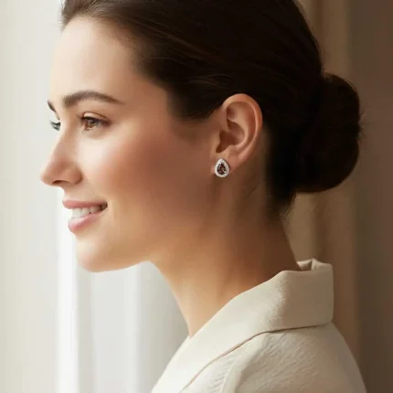 model wearing silver studs cluster with 7x5 mm pear smoky quartz and cubic zirconia