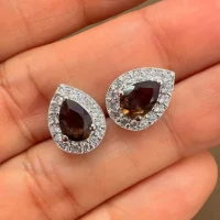 silver studs cluster with 7x5 mm pear smoky quartz and cubic zirconia displayed on hand