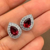 silver studs cluster with 7x5 mm pear Garnet and cubic zirconia displayed on hand