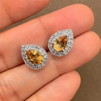 silver studs cluster with 7x5 mm pear Citrine and cubic zirconia displayed on hand