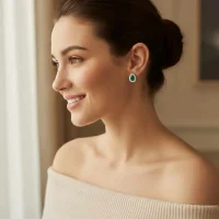 model wearing silver studs cluster with 7x5 mm pear green onyx and cubic zirconia