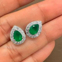 silver studs cluster with 7x5 mm pear green onyx and cubic zirconia displayed on hand