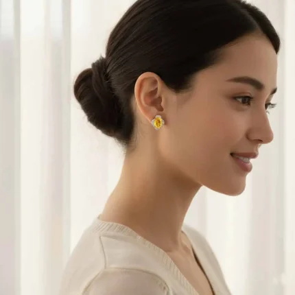 model wearing silver studs with 7x9 mm oval Citrine and cubic zirconia