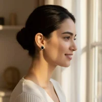 model wearing silver studs with 7x9 mm oval Black Onyx and cubic zirconia